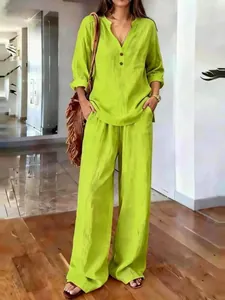 Full view of women's lime green linen-like two-piece casual set in a bright room