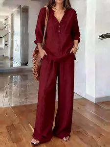 Elegant burgundy linen-textured two-piece set featuring loose top and wide pants.