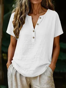 Close-up detail of a casual white cotton linen V-neck shirt with natural wooden buttons