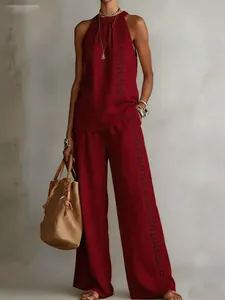 Detailed view of burgundy retro sleeveless top and lace hollow wide-leg pants set