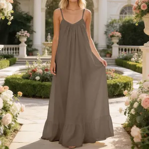 Elegant taupe spaghetti strap maxi dress with ruffled hem in garden setting