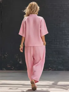Back view of a casual pink two-piece set featuring a loose top and wide-leg trousers