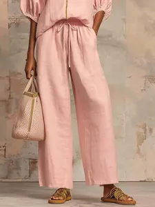 Pink linen-like casual two-piece set featuring wide-leg pants and matching zipper top.