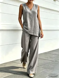 Full view of grey V-neck sleeveless top and flowing wide-leg pants on a walking model