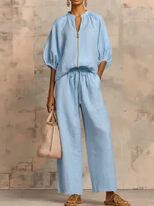 Casual light blue two-piece set featuring a zipper top and wide-leg trousers