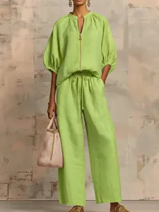 Detail of lime green casual two-piece set with puffed sleeves and wide-leg trousers