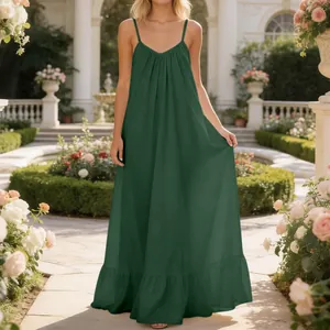 Elegant dark green spaghetti strap maxi dress with ruffled hem in a sunlit garden setting