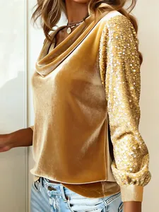 Close-up of gold velvet cowl neck top with shimmering sequin patchwork sleeves.