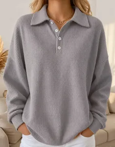 Detailed view of women's grey waffle knit long sleeve polo shirt with lapel collar