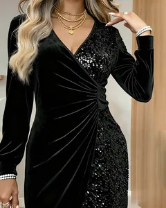 Close-up detail of black velvet V-neck dress with shimmering sequin panels and ruched waist