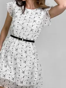 Close-up view of a white French-style heart print dress with elegant flutter sleeves