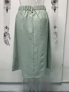 Back view of a light green A-line midi skirt with an elastic waistband on a mannequin