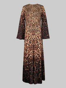 Detail view of a leopard print maxi jumpsuit featuring round neck and long bell sleeves