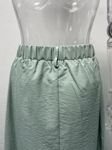 Close-up detail of sage green elastic waistband on casual cargo midi skirt for women