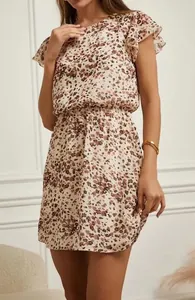 Close-up showing the intricate floral pattern and flutter sleeve detail of the summer dress