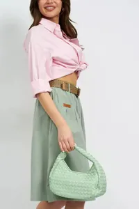 Model wearing sage green elastic waist A-line midi skirt with utility pocket