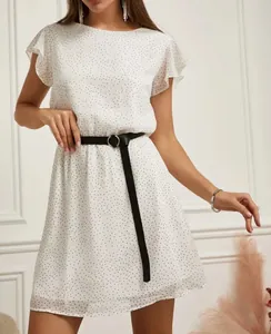 Close-up detail of white polka dot flutter sleeve A-line dress with a black waist belt.
