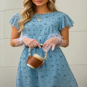 Detailed view of light blue floral dress with flutter sleeves and A-line silhouette