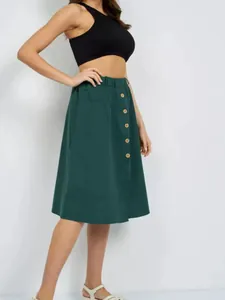 Detailed side view of dark green midi skirt showing button front and elastic waist