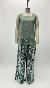 Front detail view of green sleeveless top and botanical print wide-leg trousers set