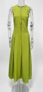 Detail showing the chartreuse sleeveless maxi dress with a front zipper on a mannequin