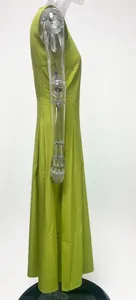 Side view detail of a lime green sleeveless high-waisted maxi dress on a clear mannequin.
