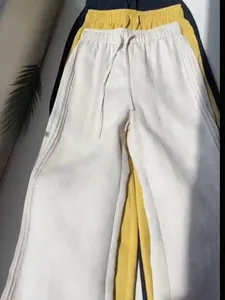 Detailed view of casual wide-leg pants with drawstring waist in multiple colors