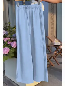 Light blue wide-leg trousers with drawstring waist, ideal for leisure or resort wear