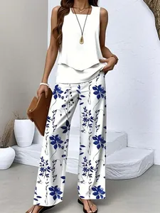 Full-body detail shot of white double-layered top and blue floral printed wide-leg pants