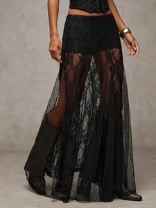 Detail view of black sheer lace maxi skirt with low-waist and polka dot mesh design.