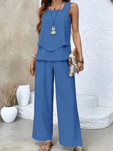 Model wearing a blue two-piece set with a double-layer sleeveless top and wide-leg pants.