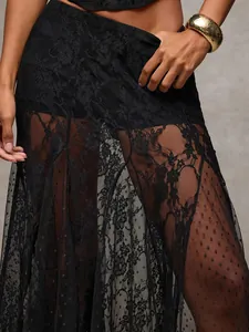 Detail view of black lace and sheer mesh maxi skirt with intricate floral patterns