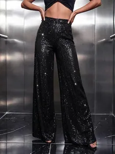 High-waisted black shimmering sequin wide-leg pants showing texture and drape in metallic setting.