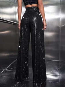 Elegant high-waisted black sequin wide-leg trousers shown from back in a party setting