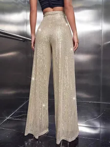 Detailed back view of gold high-waisted wide-leg trousers with shimmering sequins.