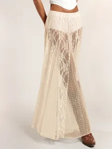 Detail showing sheer cream lace and polka dot mesh maxi skirt with intricate floral embroidery