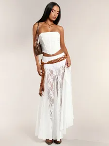 Close-up detail of white lace sheer maxi skirt featuring a bohemian woven fringe belt