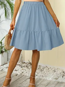 Detail view showing the soft ruffles and tiered design of this light blue summer mini skirt