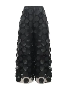Detailed view of elegant black mesh straight pants featuring unique 3D polka dot texture