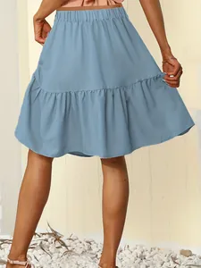 Back view detail of a blue high-waisted mini skirt with a stylish ruffled hem.