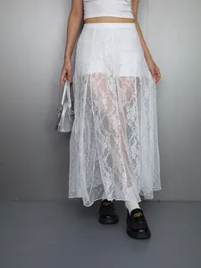Detailed view of a white lace sheer maxi skirt featuring delicate floral patterns and textures