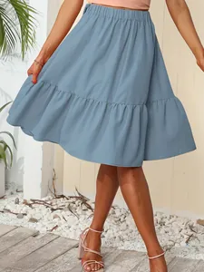 Detailed view of a dusty blue pleated mini skirt featuring a ruffled hem and elastic waist