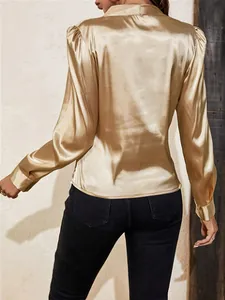 Detail view of a luxury champagne gold satin shirt with elegant lantern sleeves from the back