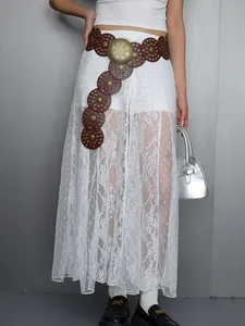 Detailed view of white floral lace semi-sheer maxi skirt with stylish layering