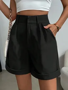 Macro detail showing texture of women's high-waisted black pleated shorts with pockets