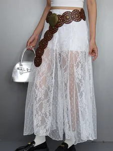 Detailed view of the intricate floral lace texture on this white sheer maxi skirt