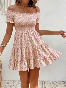 Detailed view of a vintage floral off-shoulder dress with smocked bodice texture