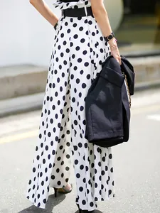 Detailed back view of trendy high-waisted white and black polka dot wide-leg pants