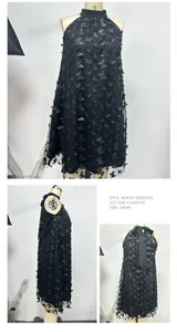 Detailed views of the 3D butterfly appliqués and halter neck design on a black mesh dress
