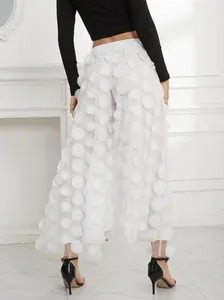 Elegant women's white mesh wide-leg trousers featuring unique 3D polka-dot petal appliques.